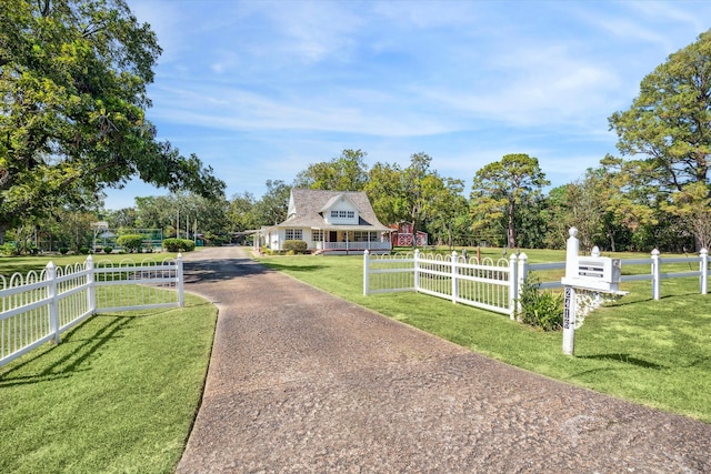 view of front facade featuring a rural view and a front yard