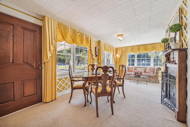 carpeted dining space with a wealth of natural light