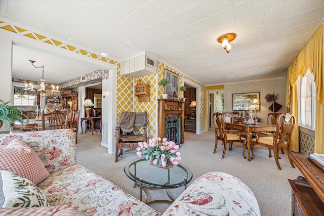 living room with light colored carpet, an inviting chandelier, and wooden walls