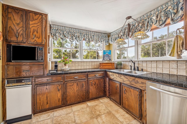 kitchen with backsplash, hanging light fixtures, sink, and dishwasher