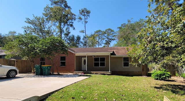 ranch-style home featuring a front yard