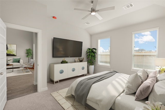 bedroom with light wood-type flooring, multiple windows, lofted ceiling, and ceiling fan