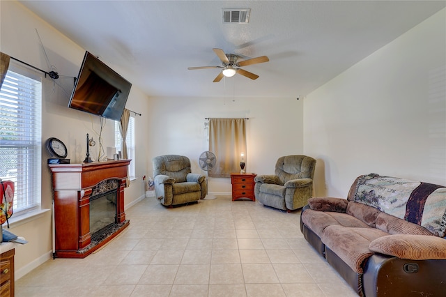 living room featuring ceiling fan and light tile patterned flooring