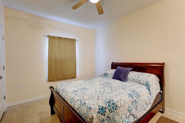 tiled bedroom featuring ceiling fan