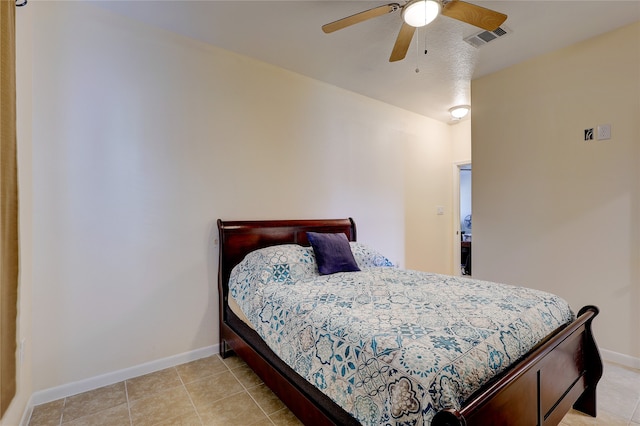 bedroom with ceiling fan and light tile patterned floors