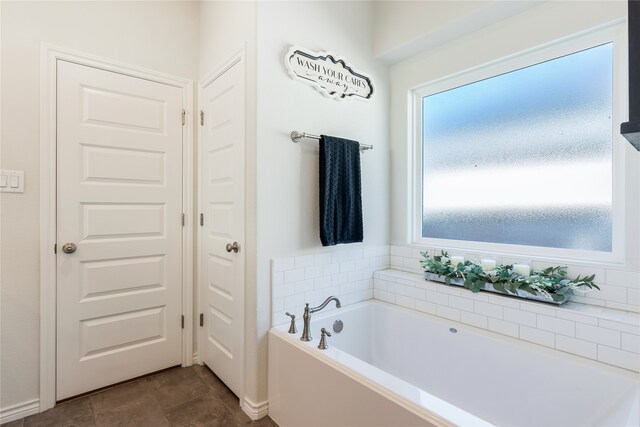 bathroom featuring tile patterned flooring and a washtub