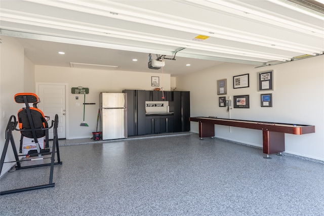 garage with a garage door opener and fridge