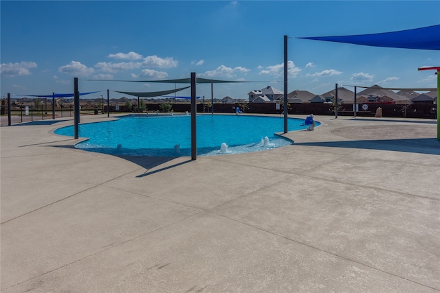 view of swimming pool featuring pool water feature and a patio area