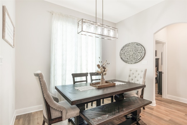 dining room featuring an inviting chandelier and light hardwood / wood-style floors