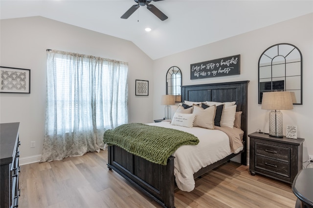 bedroom with light hardwood / wood-style floors, lofted ceiling, and ceiling fan