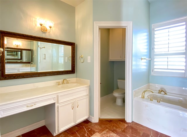 bathroom featuring a tub to relax in, vanity, and toilet