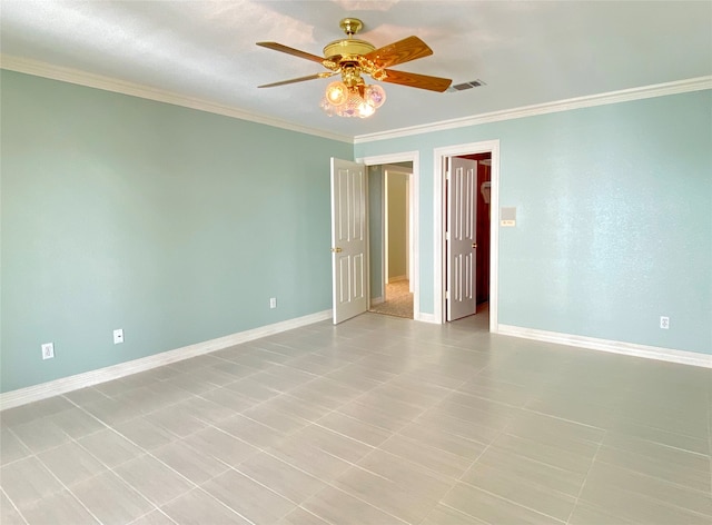 tiled spare room with ceiling fan and ornamental molding