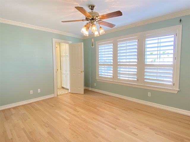 interior space with ornamental molding, light wood-type flooring, and ceiling fan