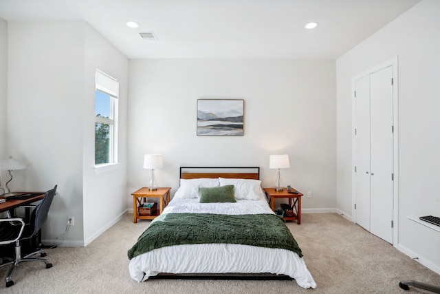 bedroom featuring light colored carpet