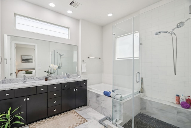 bathroom featuring vanity and plus walk in shower