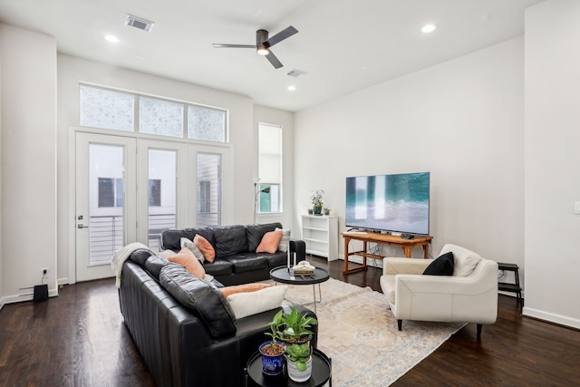 living room featuring ceiling fan and dark hardwood / wood-style flooring