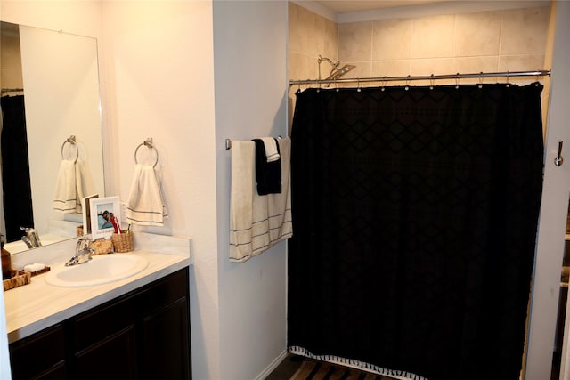 bathroom with walk in shower and vanity