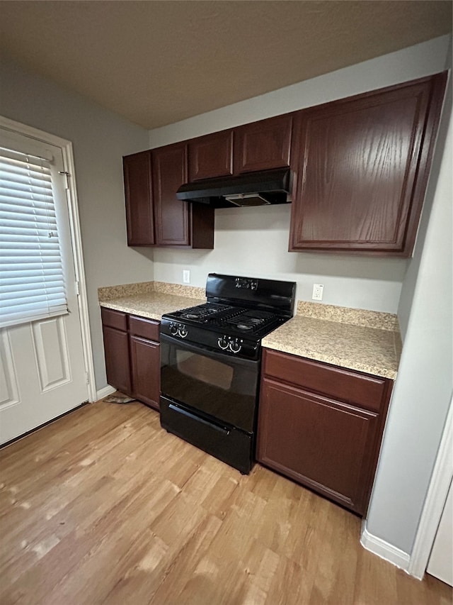 kitchen featuring light hardwood / wood-style flooring, dark brown cabinetry, and black range with gas cooktop