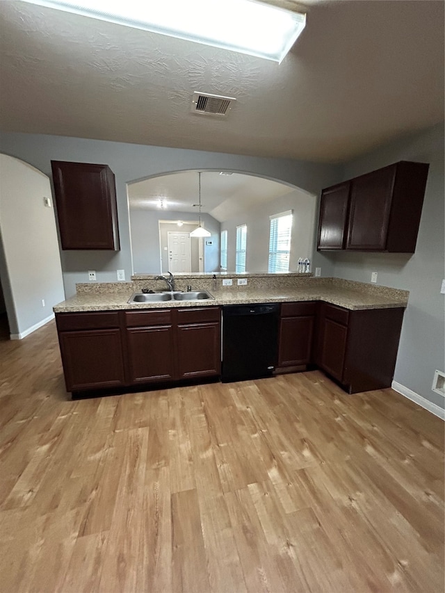 kitchen featuring dishwasher, lofted ceiling, dark brown cabinets, light hardwood / wood-style flooring, and sink