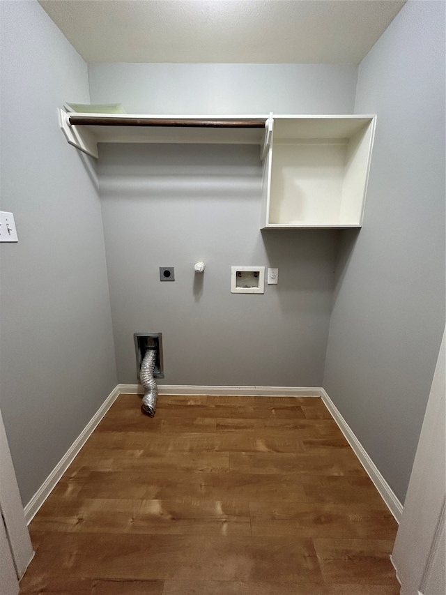 clothes washing area with washer hookup, electric dryer hookup, gas dryer hookup, and dark hardwood / wood-style flooring