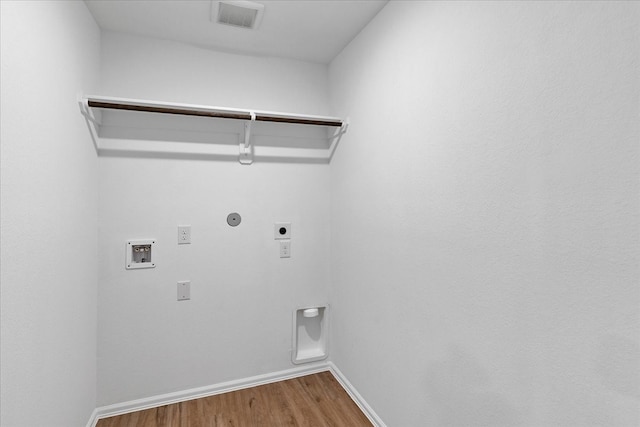 clothes washing area featuring washer hookup, hardwood / wood-style flooring, hookup for a gas dryer, and hookup for an electric dryer