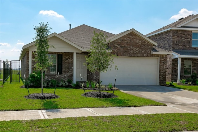 view of front of property with a front yard and a garage