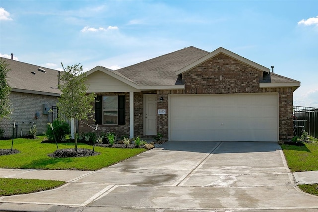 view of front of home featuring a front lawn and a garage