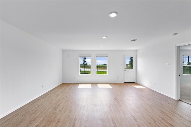 unfurnished living room with light hardwood / wood-style flooring