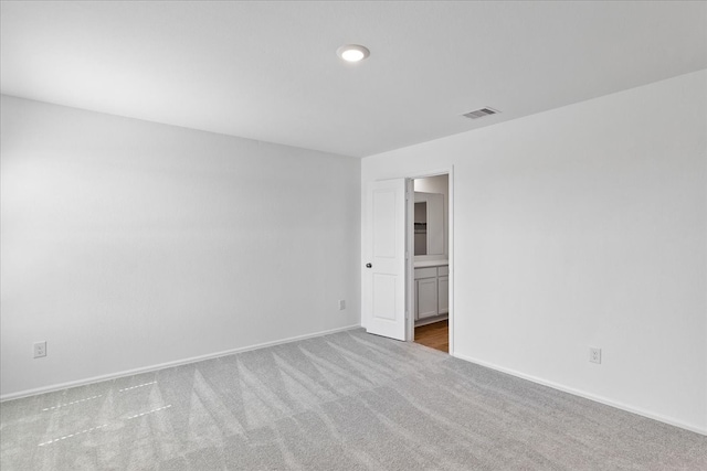 unfurnished room featuring light colored carpet