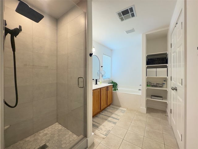 bathroom featuring tile patterned flooring, vanity, and separate shower and tub