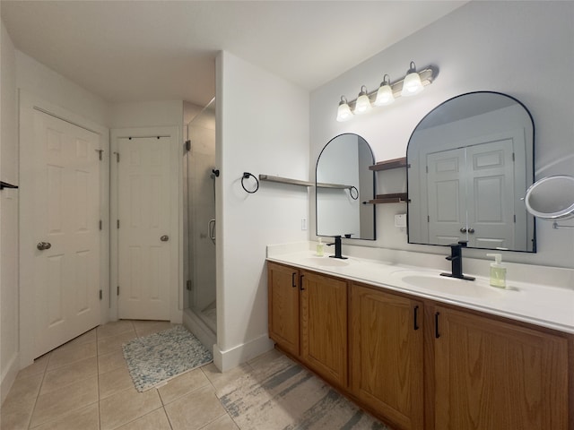 bathroom with vanity, a shower with shower door, and tile patterned floors