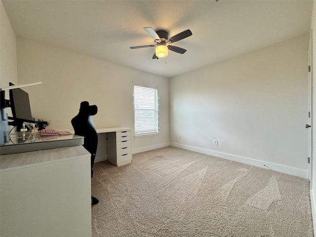 carpeted office space with ceiling fan