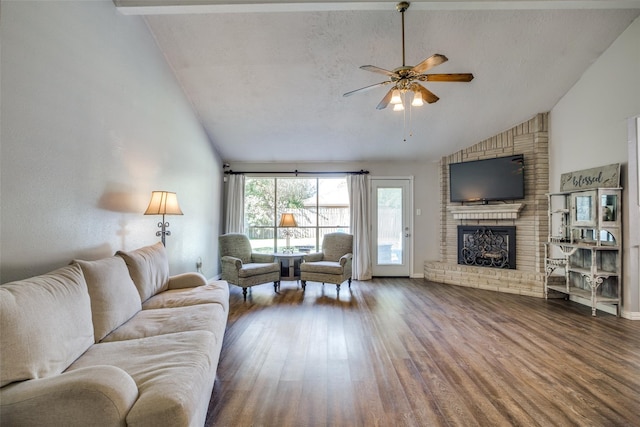 living room featuring a fireplace, hardwood / wood-style floors, ceiling fan, and high vaulted ceiling