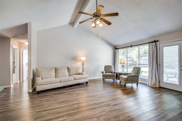 living room featuring wood-type flooring, a textured ceiling, lofted ceiling with beams, and ceiling fan