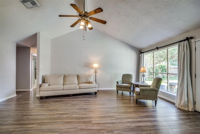 living room featuring a textured ceiling, dark hardwood / wood-style floors, ceiling fan, and a wealth of natural light