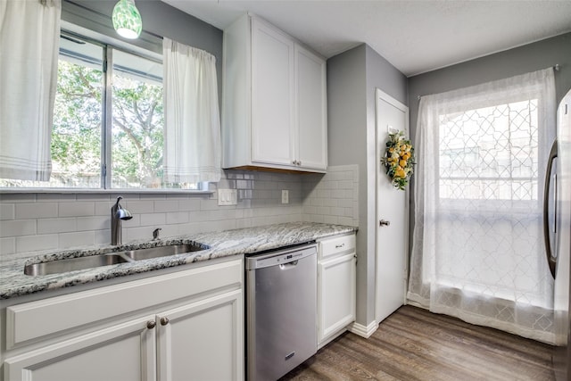 kitchen featuring appliances with stainless steel finishes, white cabinetry, dark hardwood / wood-style floors, and a wealth of natural light