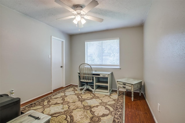 office space featuring ceiling fan, hardwood / wood-style flooring, and a textured ceiling