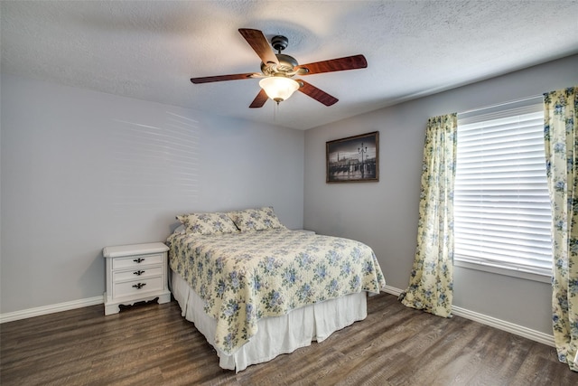 bedroom featuring ceiling fan, a textured ceiling, and dark hardwood / wood-style flooring