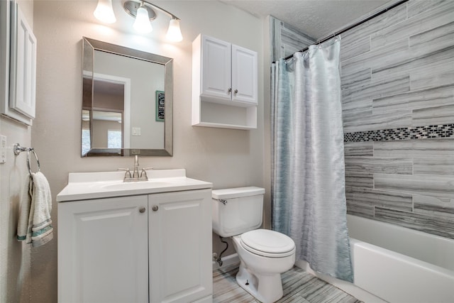 full bathroom with vanity, shower / tub combo, toilet, and a textured ceiling