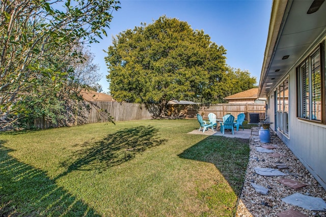 view of yard with central AC and a patio area