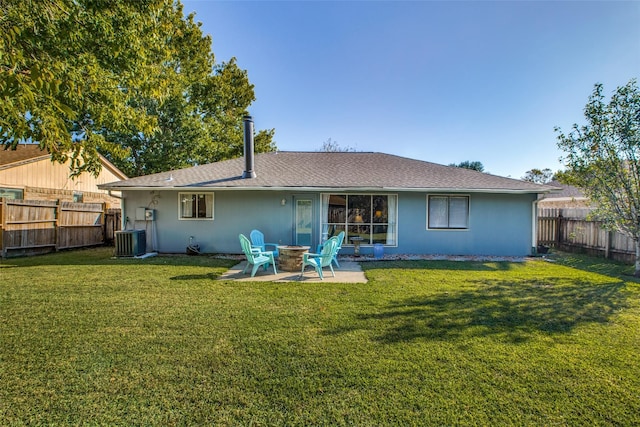 back of house featuring central air condition unit, a patio area, an outdoor fire pit, and a yard