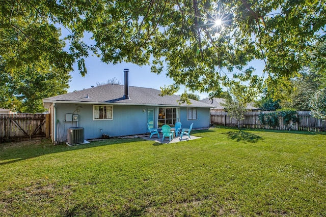 back of house featuring a patio, a yard, and central air condition unit