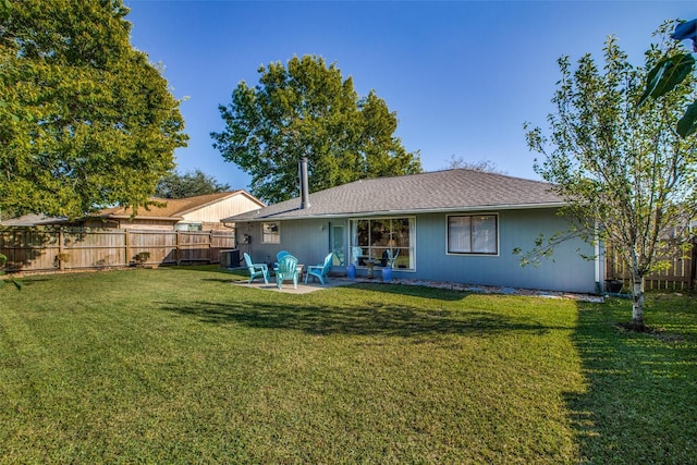 back of property featuring a lawn, a patio, and a fire pit