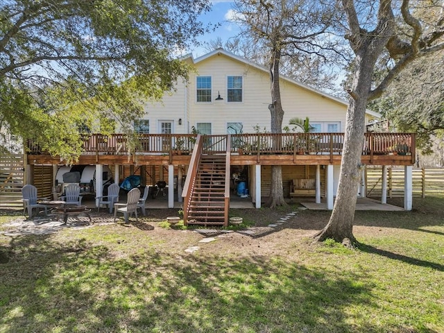 rear view of house with a patio, a yard, stairway, and a deck