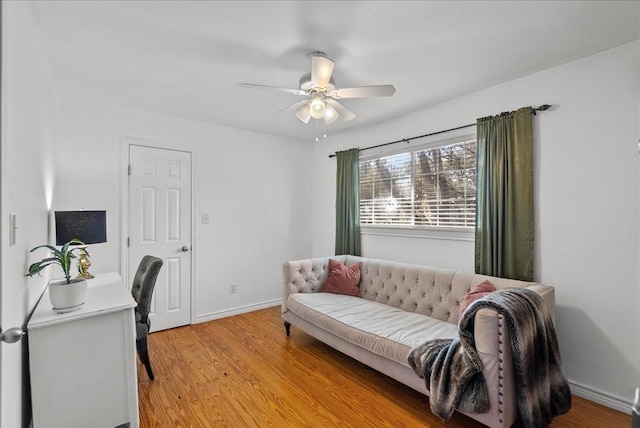 interior space featuring baseboards, ceiling fan, and light wood-style flooring