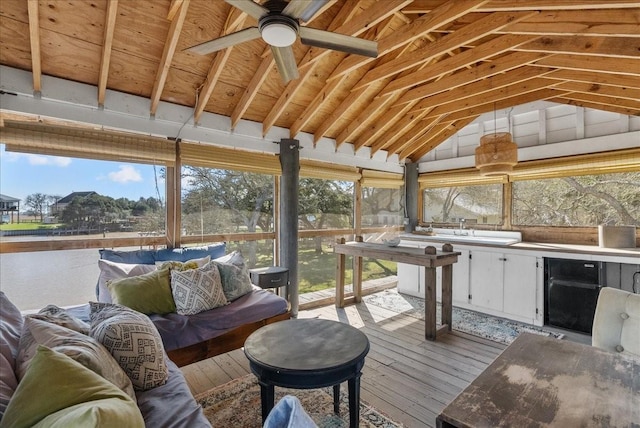 sunroom / solarium with a sink, ceiling fan, and an outdoor living space