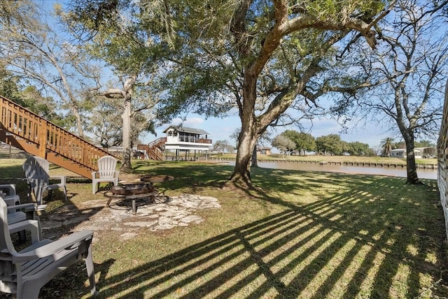 view of yard featuring a fire pit and stairway