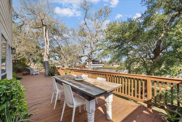 wooden deck featuring outdoor dining space