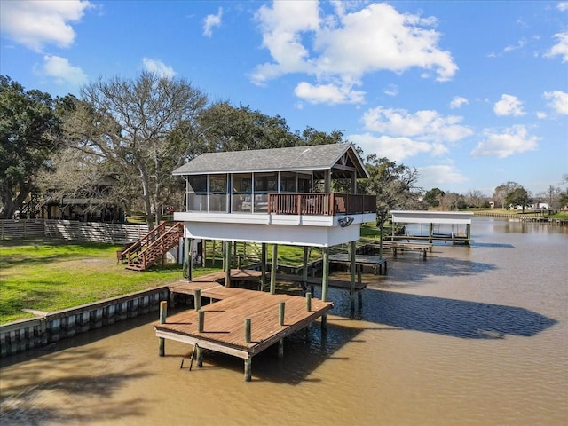 dock area featuring fence, boat lift, a water view, and stairway