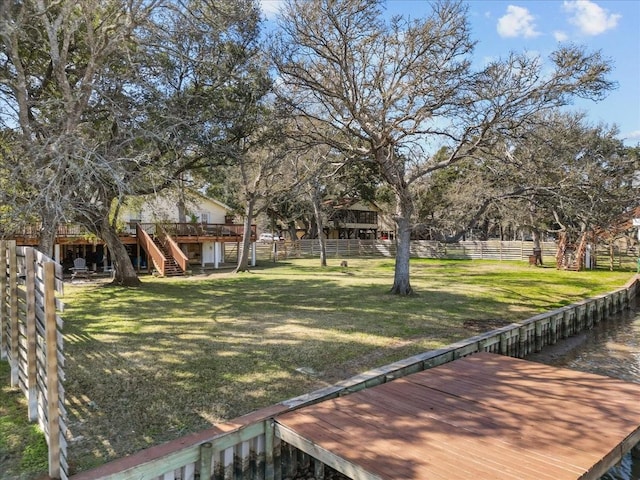 view of yard with a wooden deck, stairs, and a fenced backyard